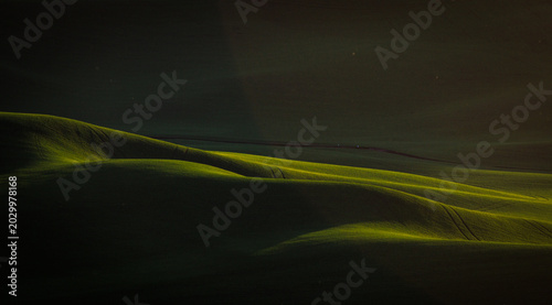 Εκτύπωση καμβά Landscapes of lushly green rolling hills with dramatic lights and shadows that create a abstract arts feels