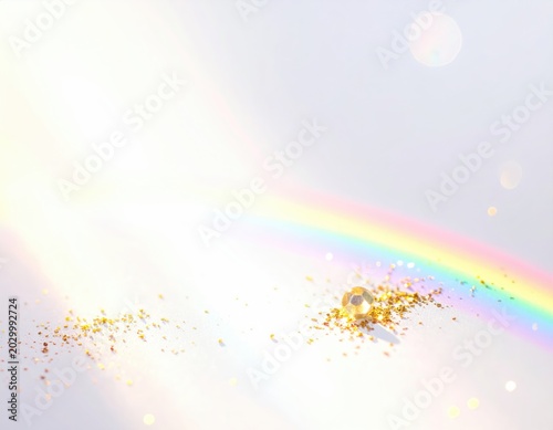 Delicate rainbow arc with golden glitter and a shimmering orb