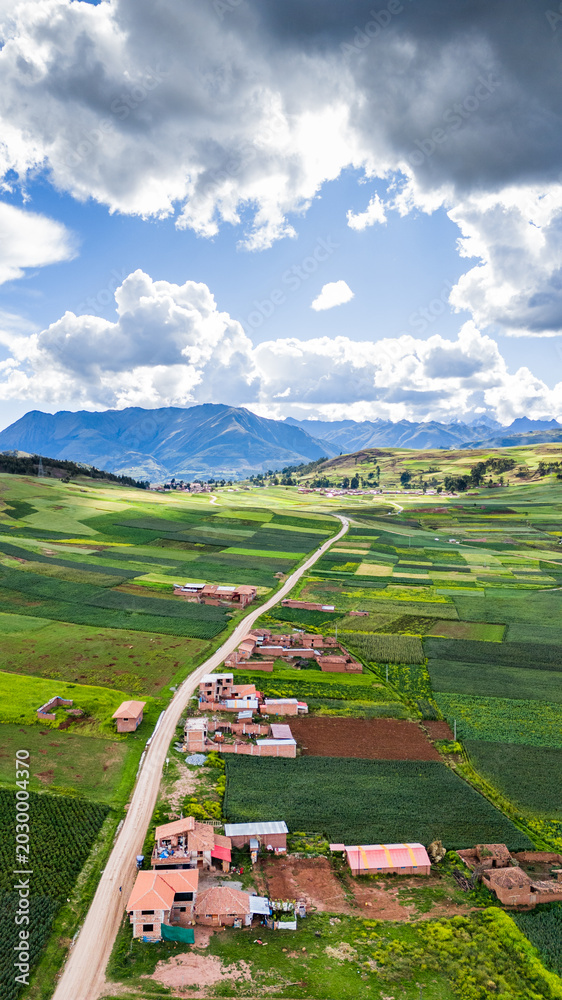 Naklejka premium Vertical aerial view of the cultivated fields near the Huaypo lagoon in the Sacred Valley of the Incas in Cusco, Peru