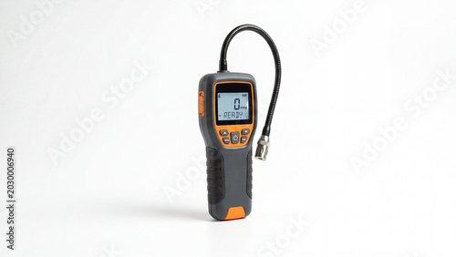 Modern electronic gas detector with digital display and black tube on white background