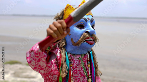 Photography Traditional Masked Performer Holding Sword Near Riverside