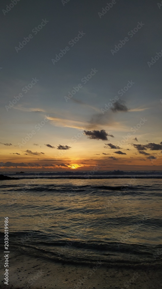 Obraz premium sunset over the sea orange sunset dark sky