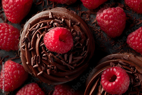 Delicious chocolate desserts with raspberries and chocolate shavings closeup