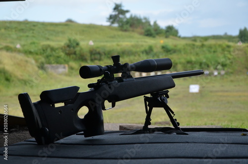 Bild auf Leinwand Tactical sniper rifle with optical scope on bipod at outdoor shooting range
