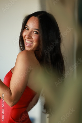 Young woman dressed in red smiling