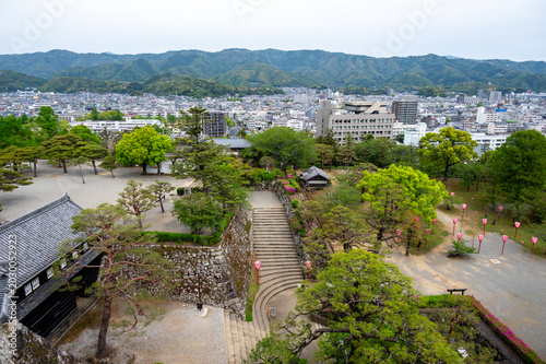 Aerial view of Kochi Castle stone walls and park with festival lanterns, Japan