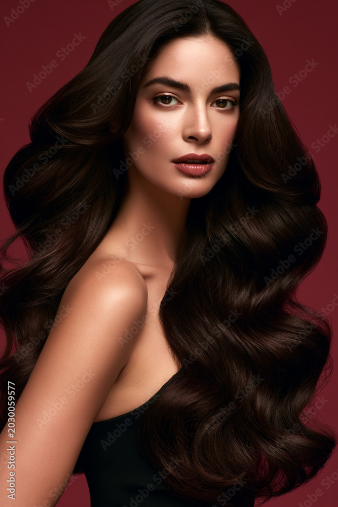 Fototapeta premium luxury haircare portrait with ultra shiny layered hairstyle, elegant woman with healthy voluminous hair in studio, sophisticated beauty campaign with radiant glossy hairstyle