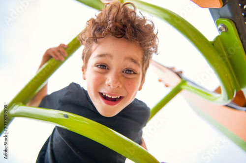 Happy kid on playground on summer season