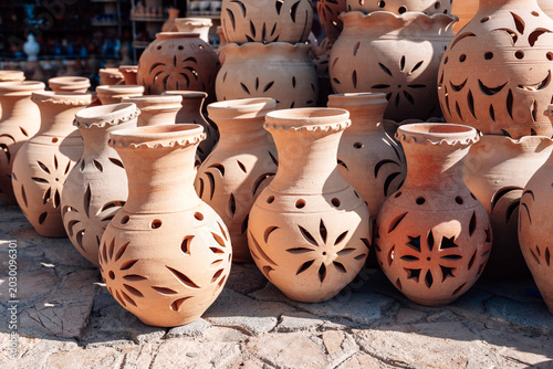Принти на полотні Traditional handmade clay pottery at outdoor market in Oman featuring decorative