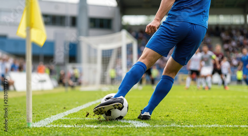 Soccer player kicking ball from corner flag. Frozen action shot of set piece
