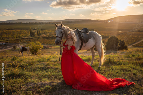 Canvastavla Woman horse sunset blonde lady in red gown stands majestically with white steed