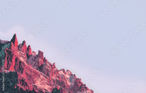 Jagged snow peak glows pink at dawn.