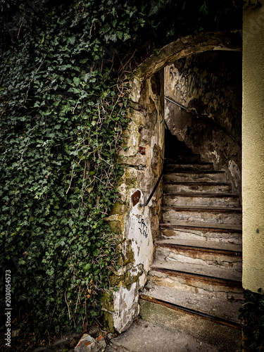 Ivy-covered historic stone staircase leading to Saint James Church in Boskovice