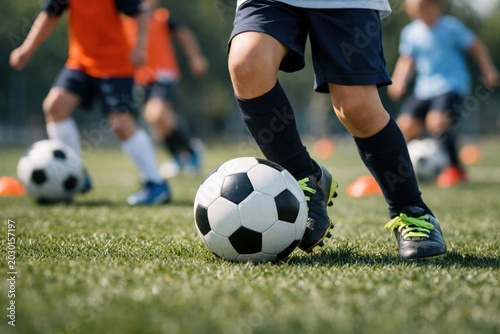 Close Up Of Young Soccer Player Dribbling Football Ball During Outdoor Youth Training Session. Football World Cup concept. Soccer concept. Childhood Football concept with copy space.
