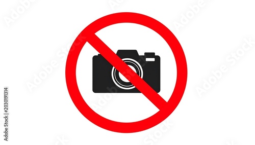 A simple sign on a white background, featuring a black camera crossed out by a red diagonal line