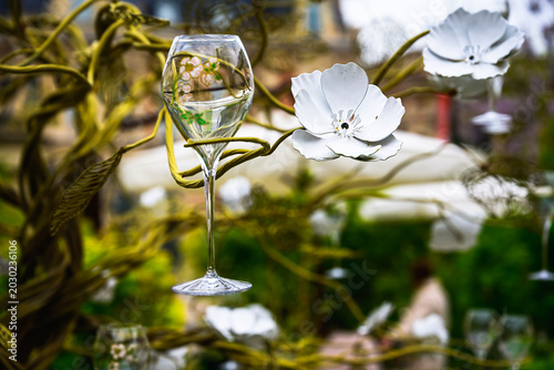 2025-04-24 A BEAUTIFUL CHAMPAGNE GLASS WITH COLORFUL DESIGN HELD UP IN A METAL FLORAL DISPLAY IN EPERNAY FRANCE