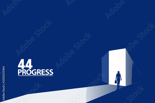 Photos A businessman walks toward bright light emanating from a doorway