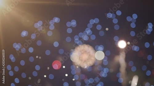 A patriotic fireworks display with a red and white bokeh effect.