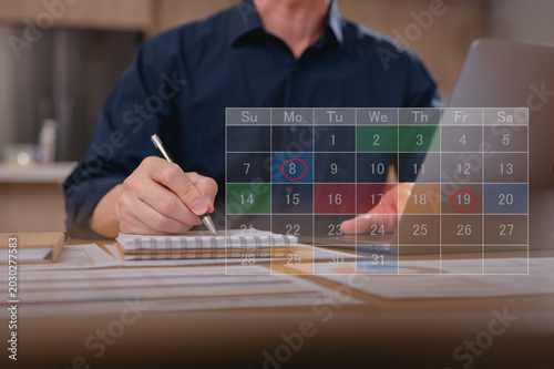 фотографія Business planning concept and Business people working writing on notebook and digital online calendar