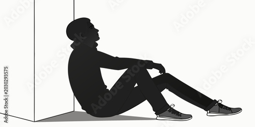 Foto Male silhouette sitting on the ground leaning back against a white wall looking