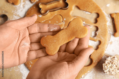 Female hands with raw dough...