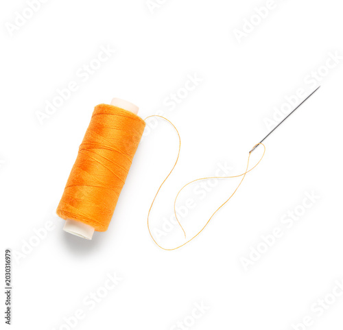 Orange sewing thread spool ...