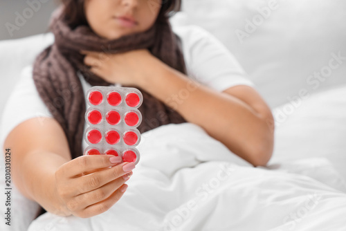 Ill young woman with throat...