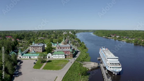 Drone footage of Nikolsky monastery and cruise ship on Volkhov river on sunny summer day. Staraya Ladoga, Russia.