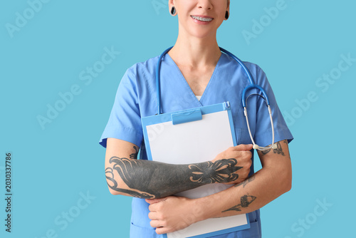 Tattooed female doctor with...