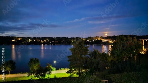 Photography Scenic Night View of Stockholm Lake with Full Moon and Starry Sky