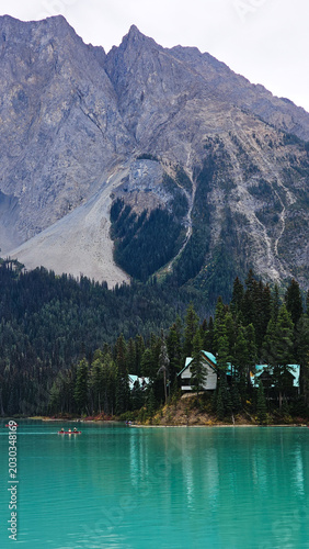 Beautiful mountain lake resort with turquoise water and cozy cabins surrounded by pine forest