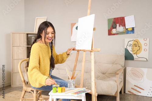 Female Asian artist paintin...