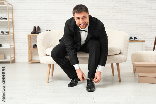 Young man in suit trying on...