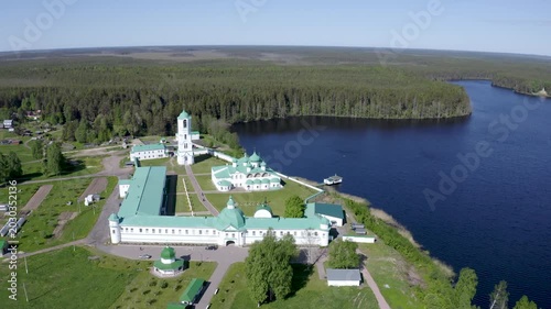 Aerial footage of Alexander-Svirsky Monastery and Roshchinskoe lake on sunny summer day. Leningrad Oblast, Russia.