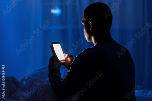 Young man using mobile phon...