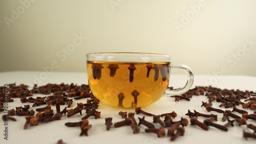 Clove tea on white table. Healthy drink.
