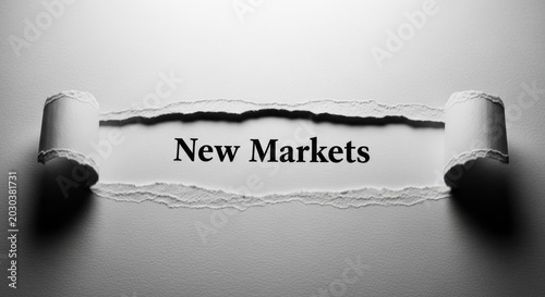 Torn Paper Revealing the Words New Markets in Black and White.