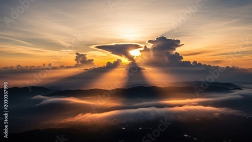 Majestic Sunrise Over Misty Mountains with God Rays.
