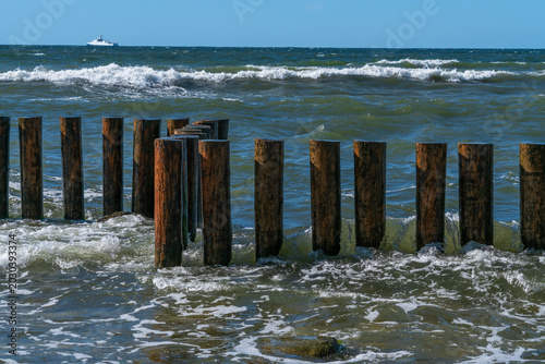 Bild auf Leinwand Baltic Sea and wooden breakwaters of the city beach on a summer day, Svetlogorsk