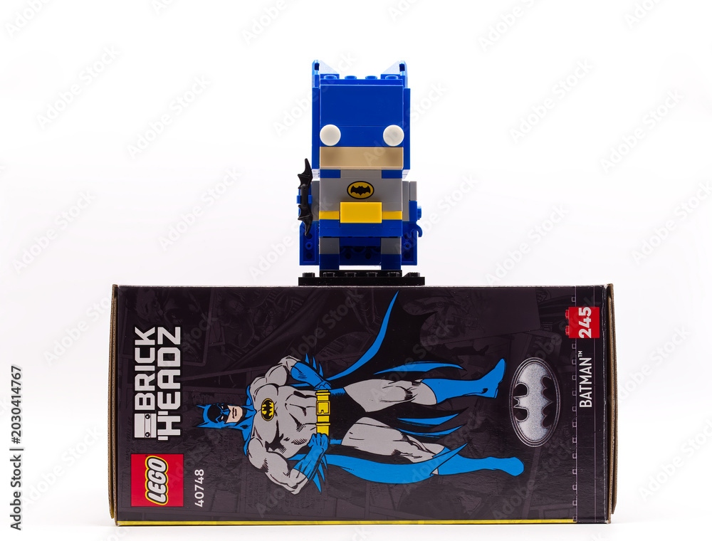 Obraz premium Bologna - Italy - April 12, 2026: Lego brickheadz batman figure standing on its original packaging box over a white background.