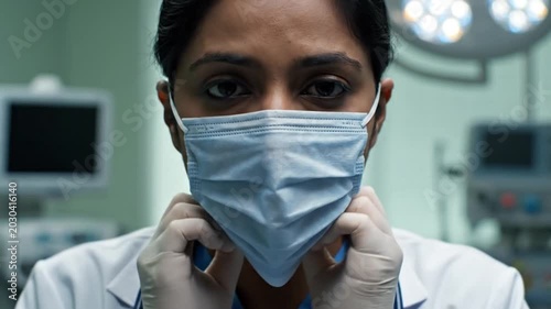 Medical Professional Handling Mask in Operating Room
