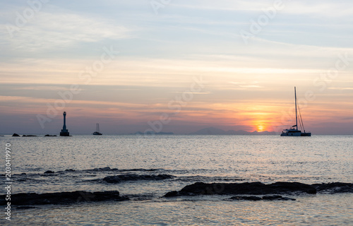 Εκτύπωση καμβά Koh Tarutao at sunset with a catamaran anchored in a calm sea