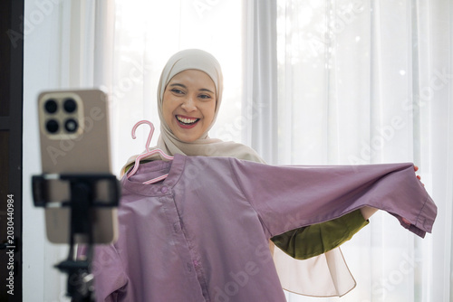 Muslim Fashion Influencer In Hijab Doing Live Video Review Of Purple Shirt For Online Shop