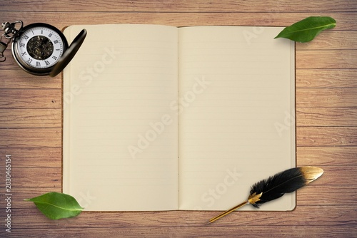 Blank open notebook with pen and measuring tape on wooden table minimalist still life