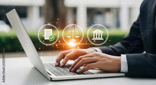 Businessman working on laptop outdoors with icons floating above keyboard