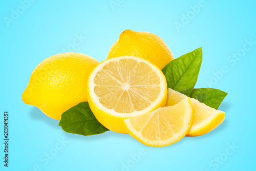 Bilde på lerret Fresh lemons and green leaves on a blue background