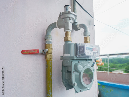 Fotografie ​Gas meter installation on an outdoor wall, natural gas utility meter with a pre