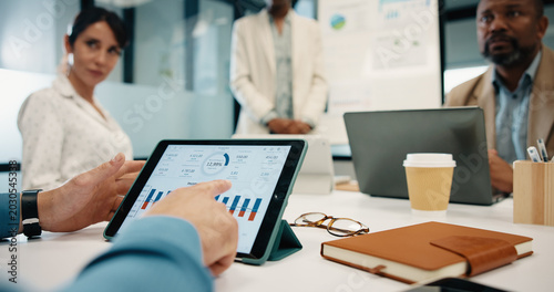 Obraz na plátně Tablet screen, hands and business people in office for meeting with statistics on finance report