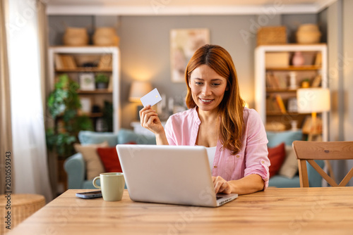 Billede på lærred Woman making online payment with credit card on laptop