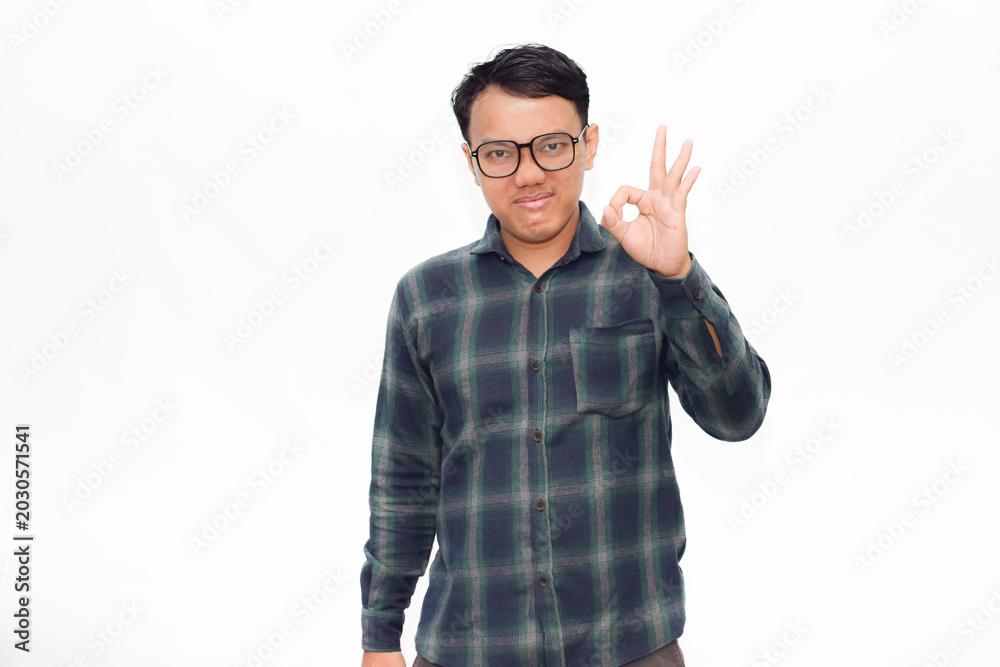 Fototapeta premium Asian man wears glasses and plaid shirt. He smiles while giving an 